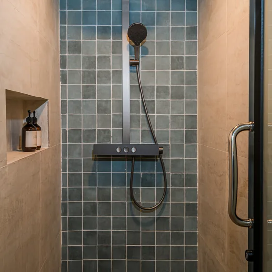 The kitchenette peninsula with blue tile and a cream kettle