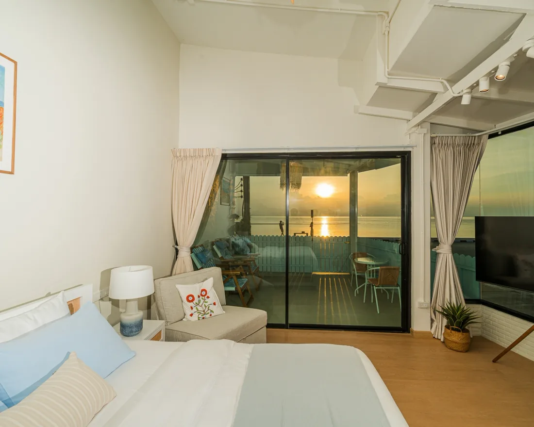 Deluxe Room with Sea View, bed facing the terrace and the sunset