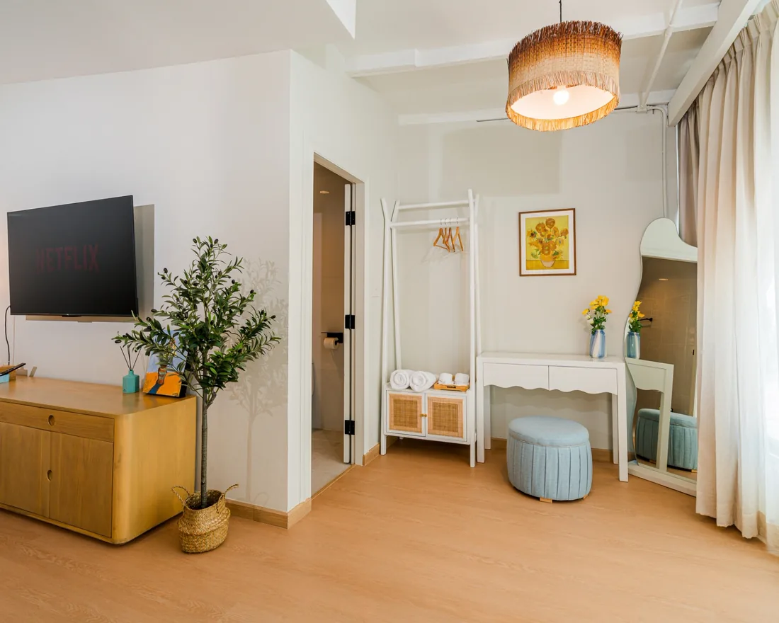 The Deluxe room, dressing area with a wavy mirror and hanging rail